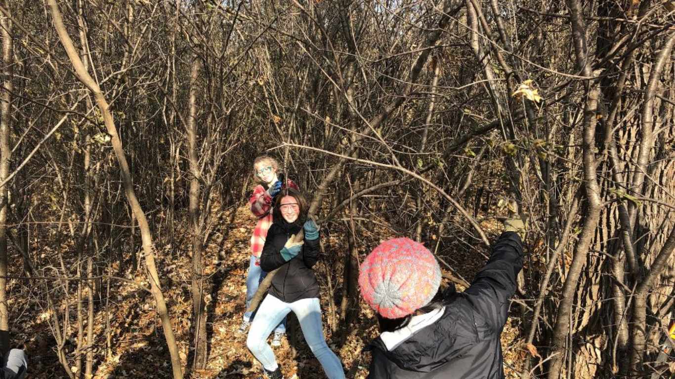 students in a wooded area